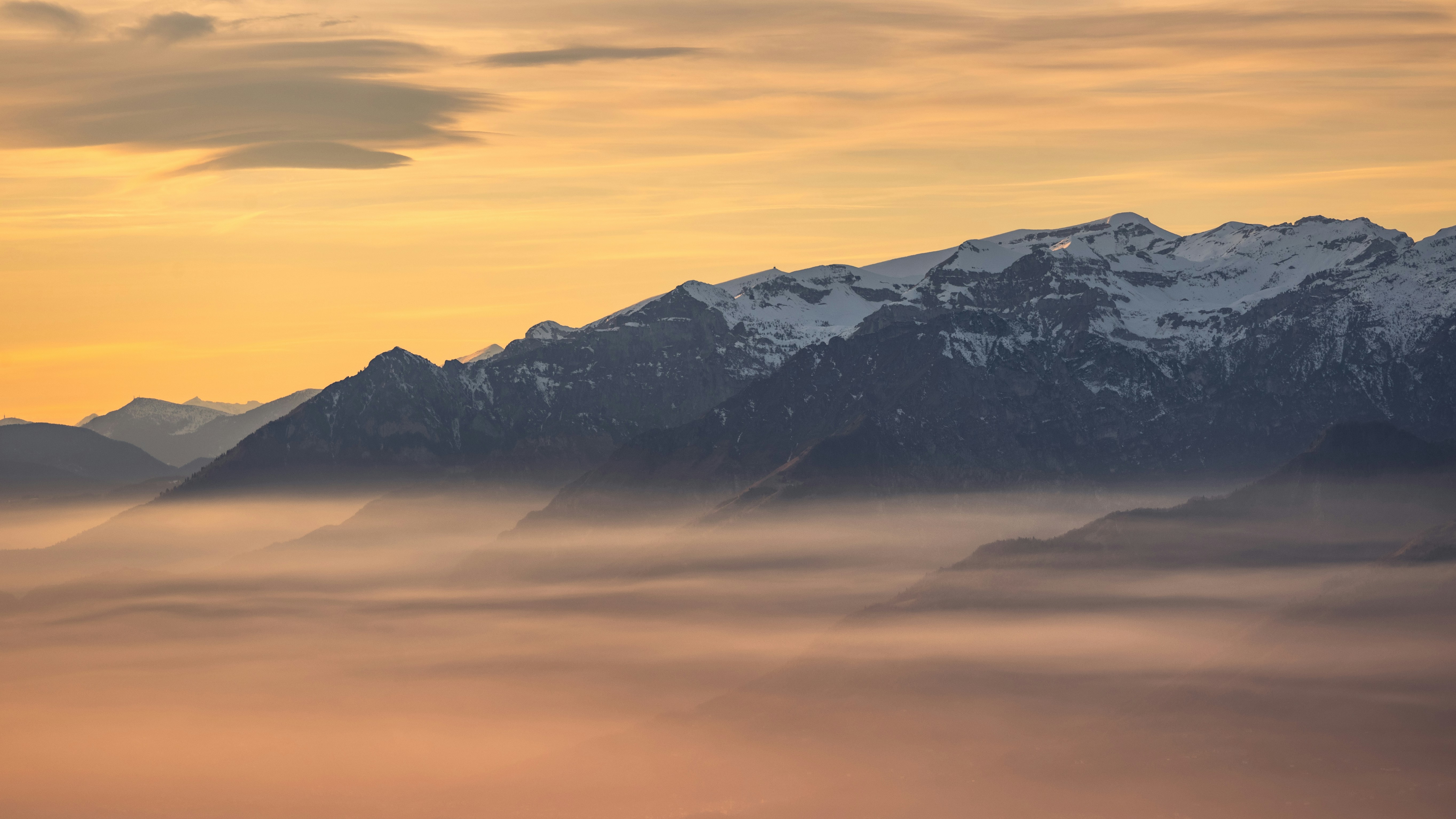 a view of a mountain range covered in fog