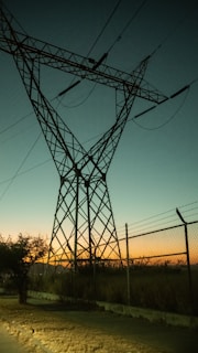 A power transmission tower equipped with zdvolt bushings during sunset, highlighting their durability.