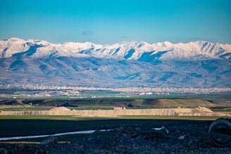 A panoramic view of Grenoble city with the Alps in the background, highlighting the local expertise.