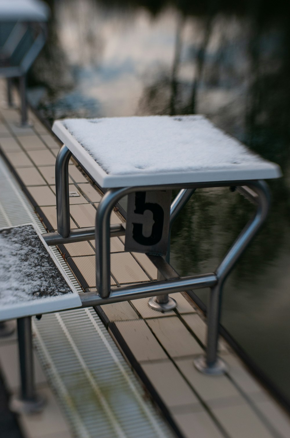 a bench that is sitting next to a body of water