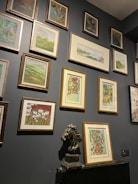 An art exhibition corner inside the horse stable with eclectic paintings and sculptures.