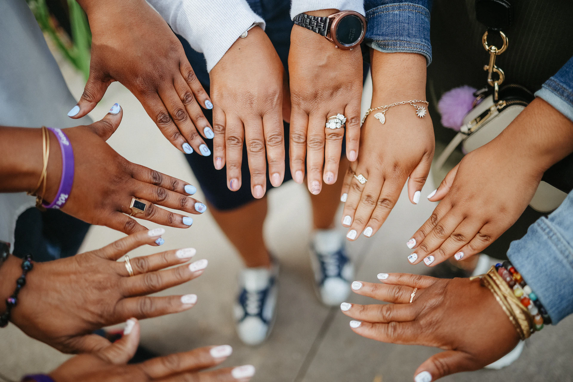 a group of people holding their hands together
