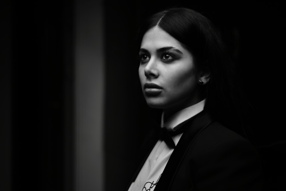 a black and white photo of a woman in a suit