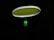 A badminton racket is suspended in the air against a black background. The strings of the racket are illuminated in a bright lime green color, contrasting with the dark surroundings. The handle of the racket is partially visible in a blurred focus.