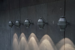 Photo of a modern linear LED lighting fixture installed on a wall in an industrial setting.