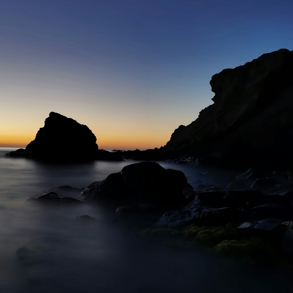 a long exposure photo of the sun setting over the ocean