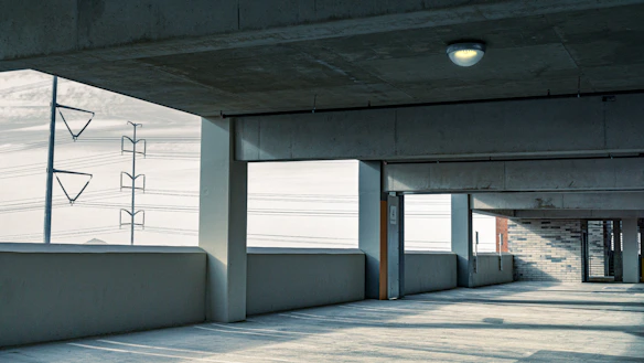 an empty parking garage with a sign on the wall