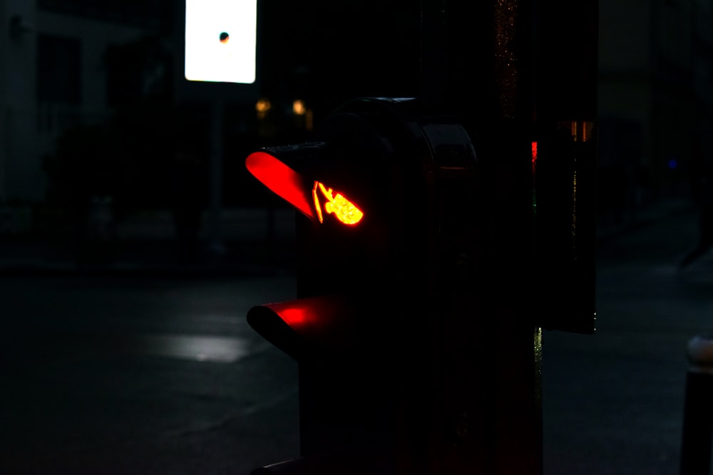 a red traffic light sitting on the side of a road