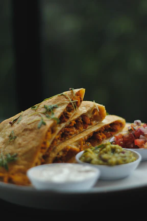 a plate topped with a quesadilla cut in half