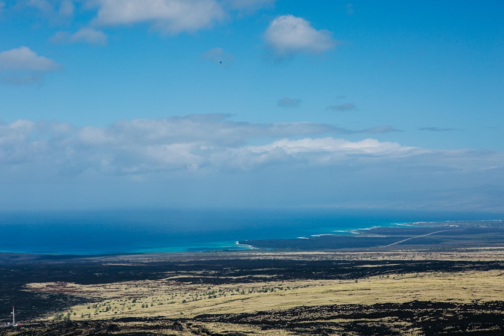 a view of the ocean from the top of a hill