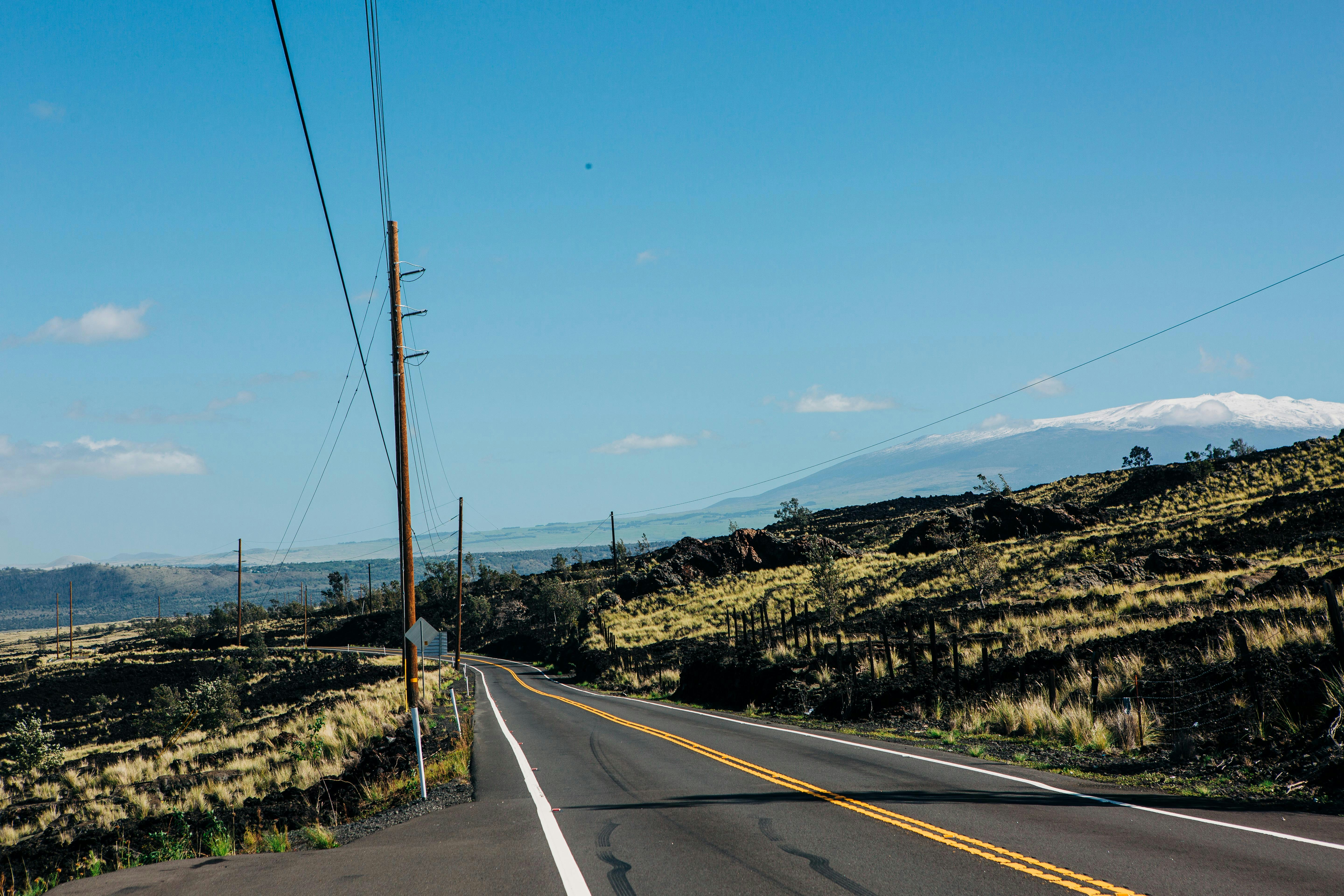 an empty road with a mountain in the background