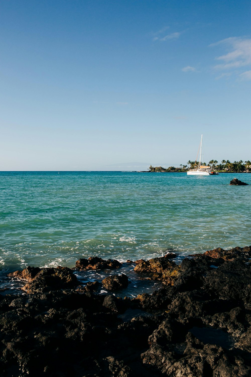 a boat is out in the ocean on a sunny day