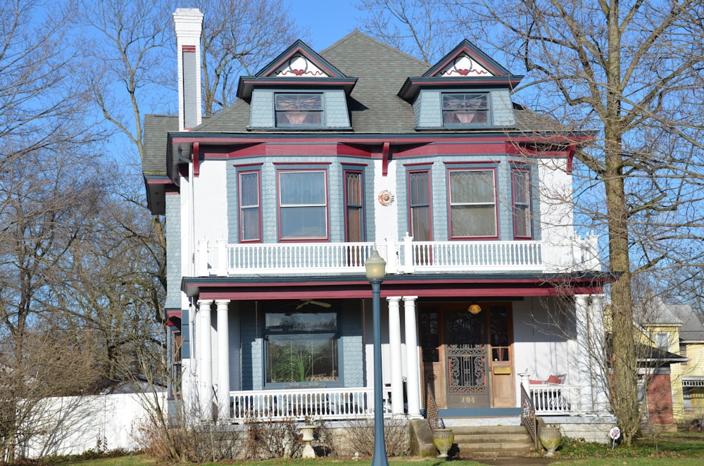 a two story house with a red and white trim