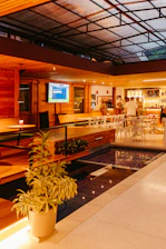 Interior view of the members bar with large screen TVs and a pool table.