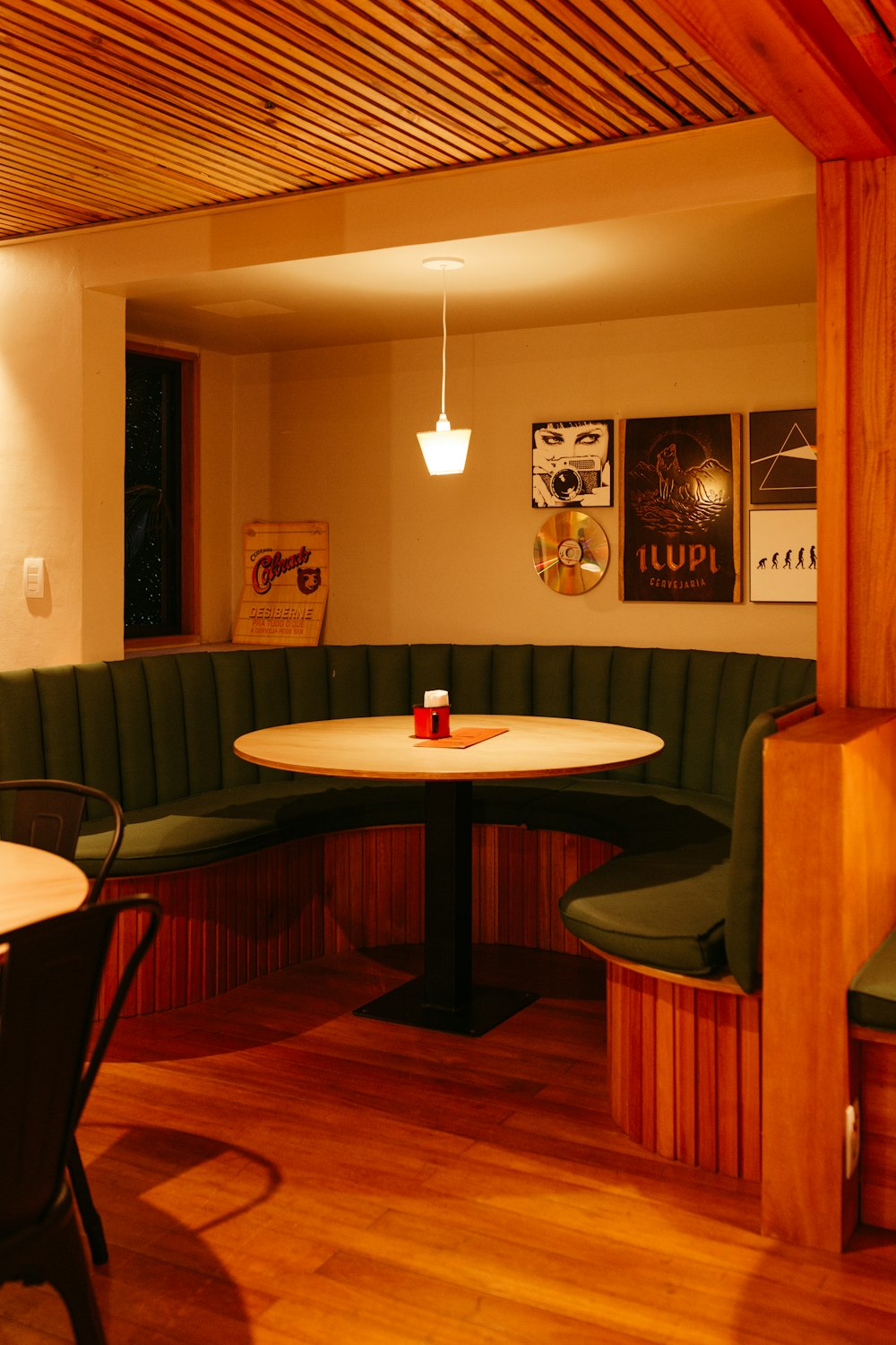 a corner booth in a restaurant with a table and chairs