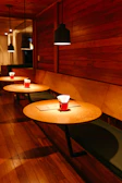 Cozy corner of the café with elegant black and red decor and classic serif menus on tables