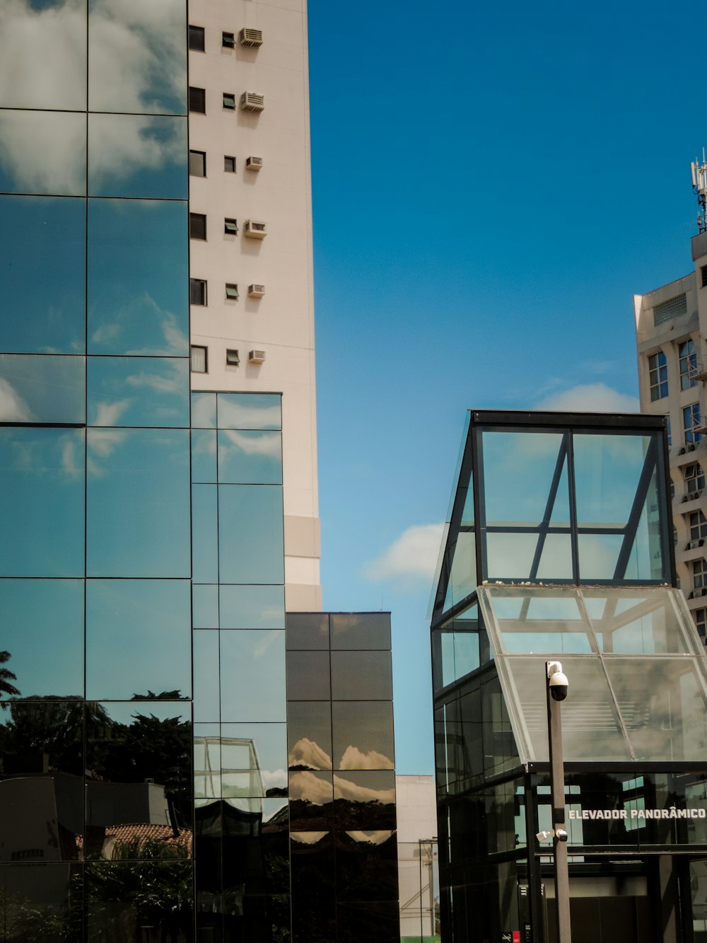 a tall building next to a tall glass building