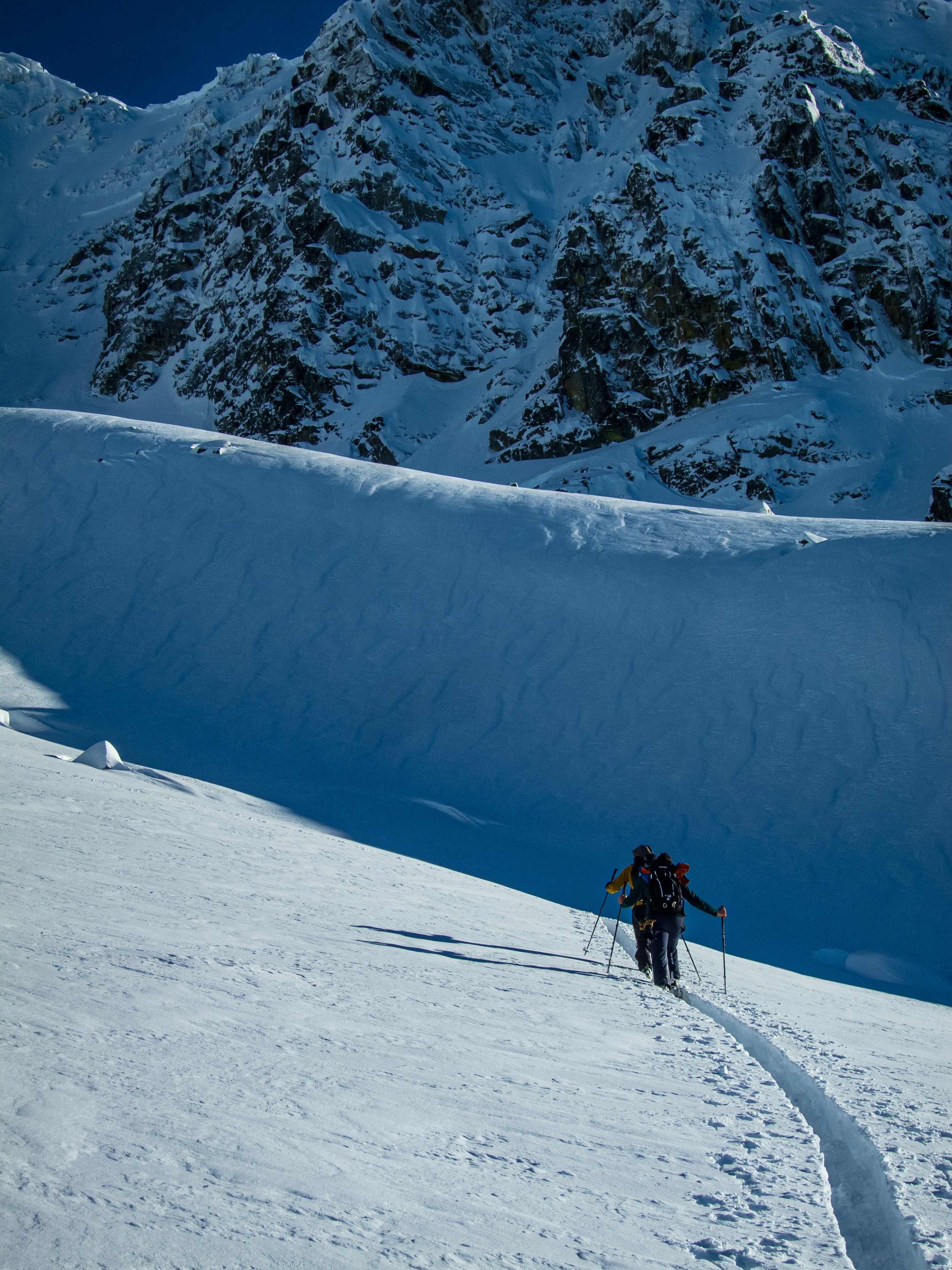 a man riding skis down a snow covered slope