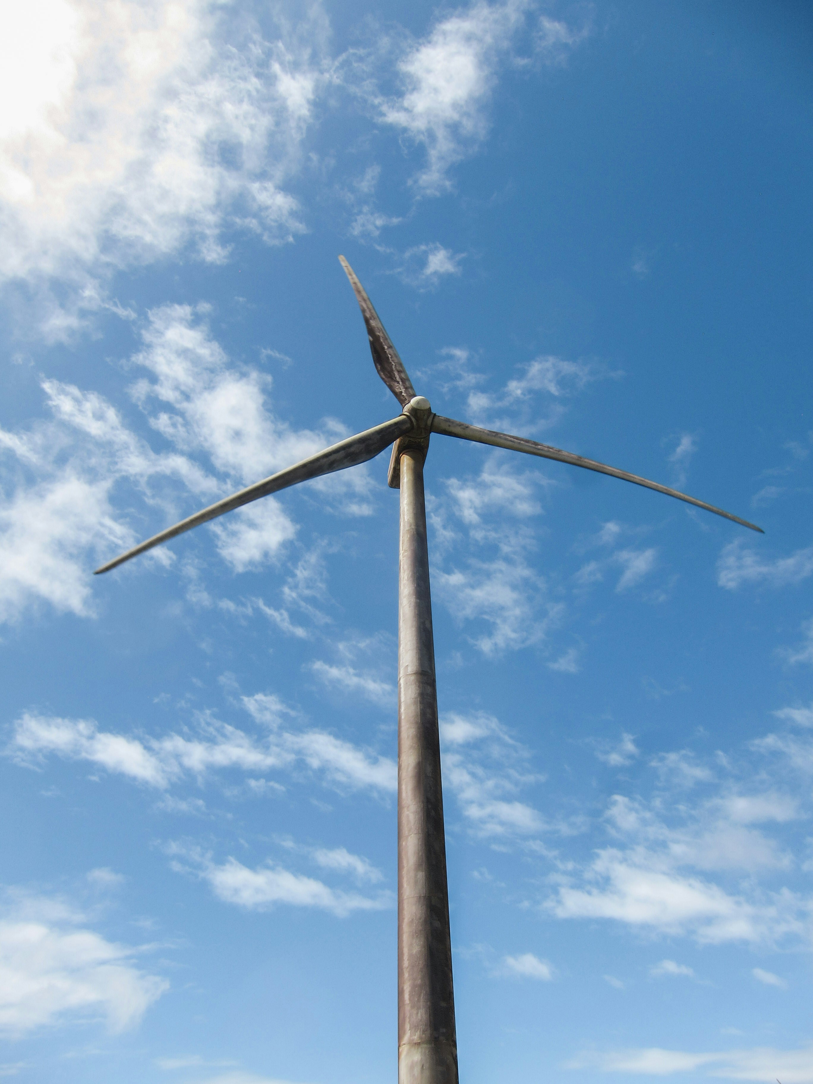 a wind turbine is shown against a blue sky