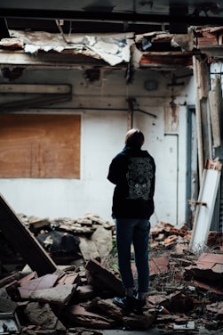 A caring professional assessing a water-damaged apartment interior with comforting demeanor.