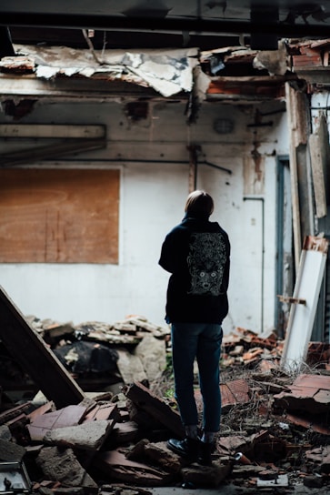 A caring professional assessing a water-damaged apartment interior with comforting demeanor.