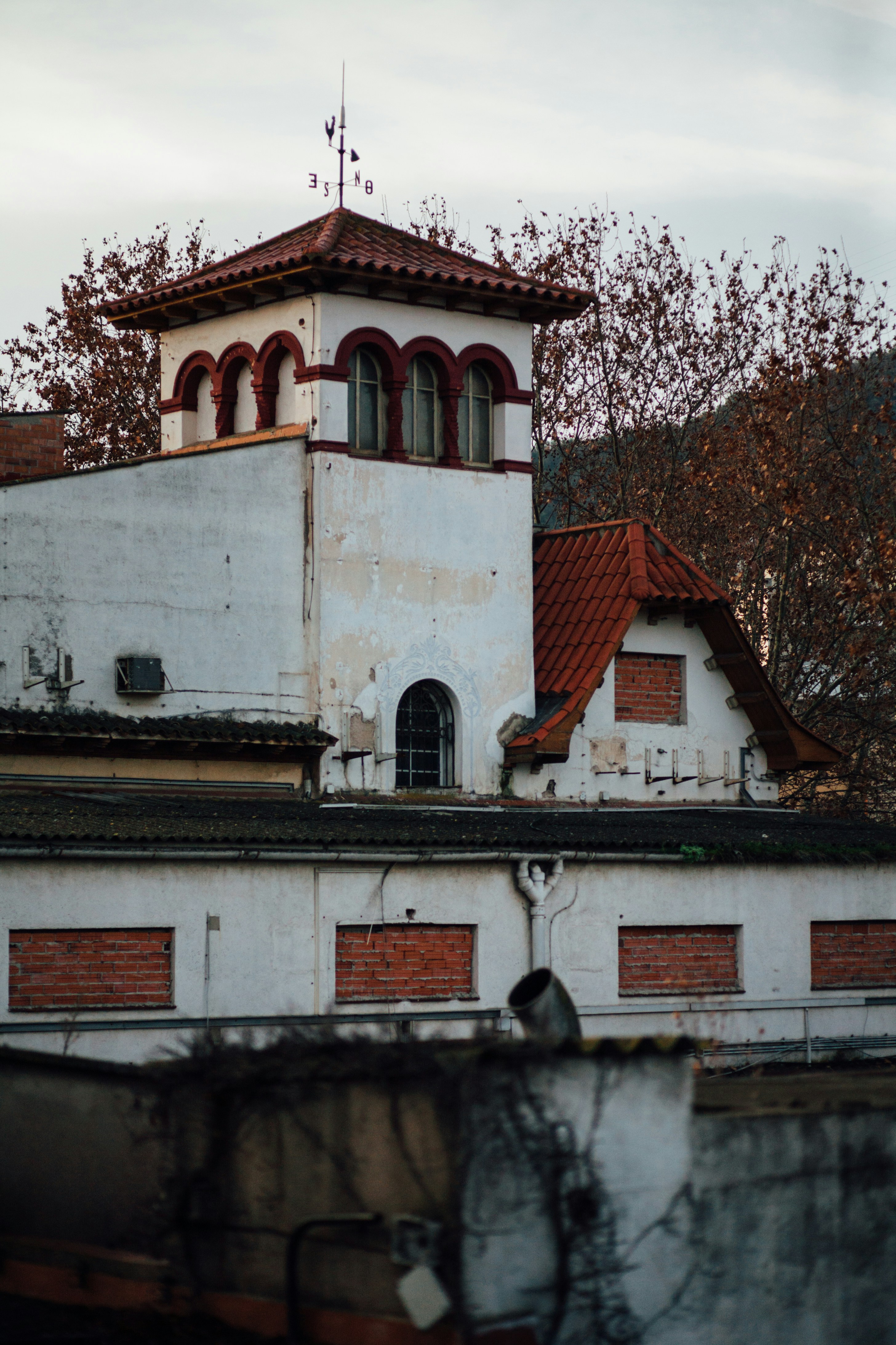 A white building with a red roof and a clock tower photo – Free Factory ...