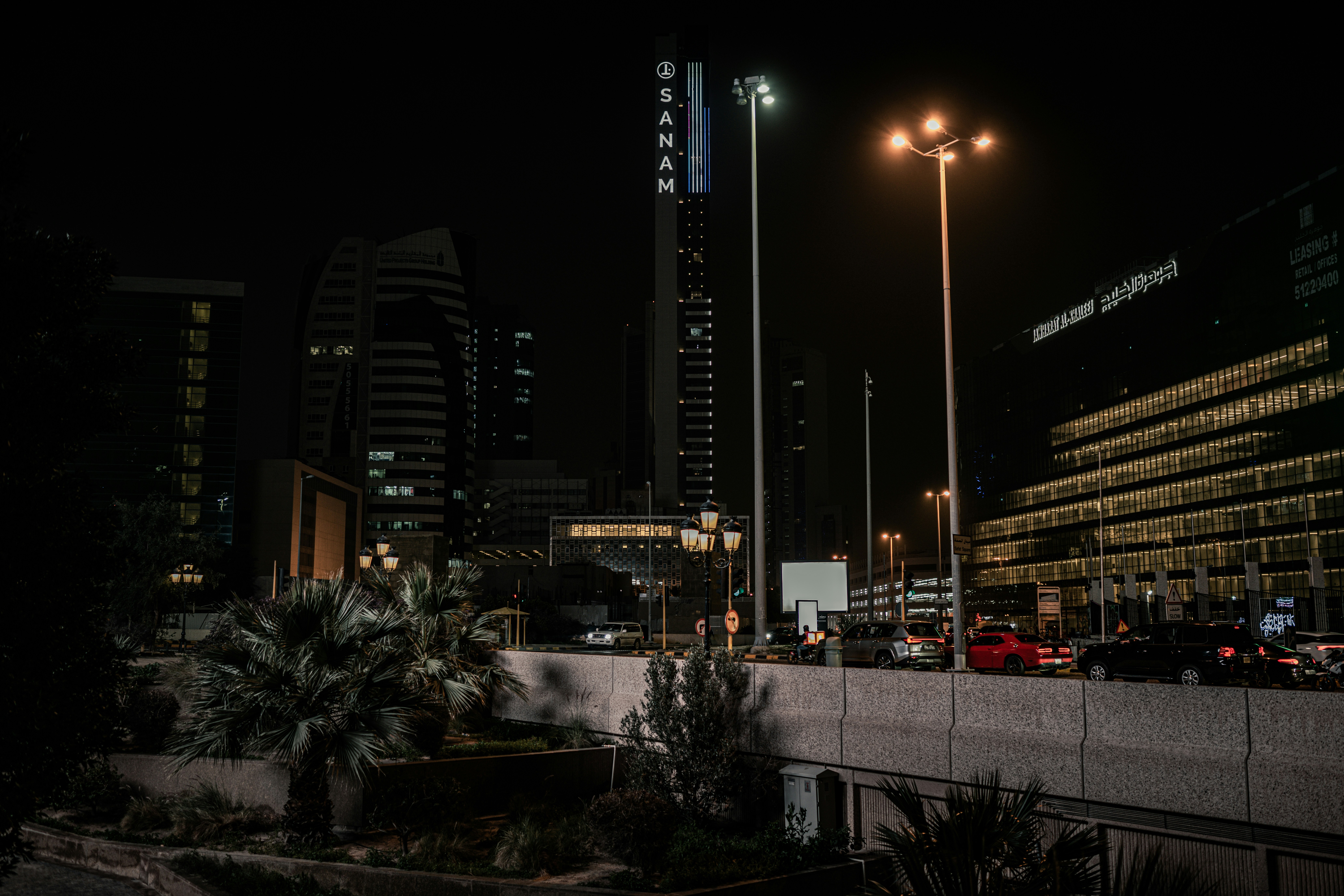 a city at night with tall buildings and street lights