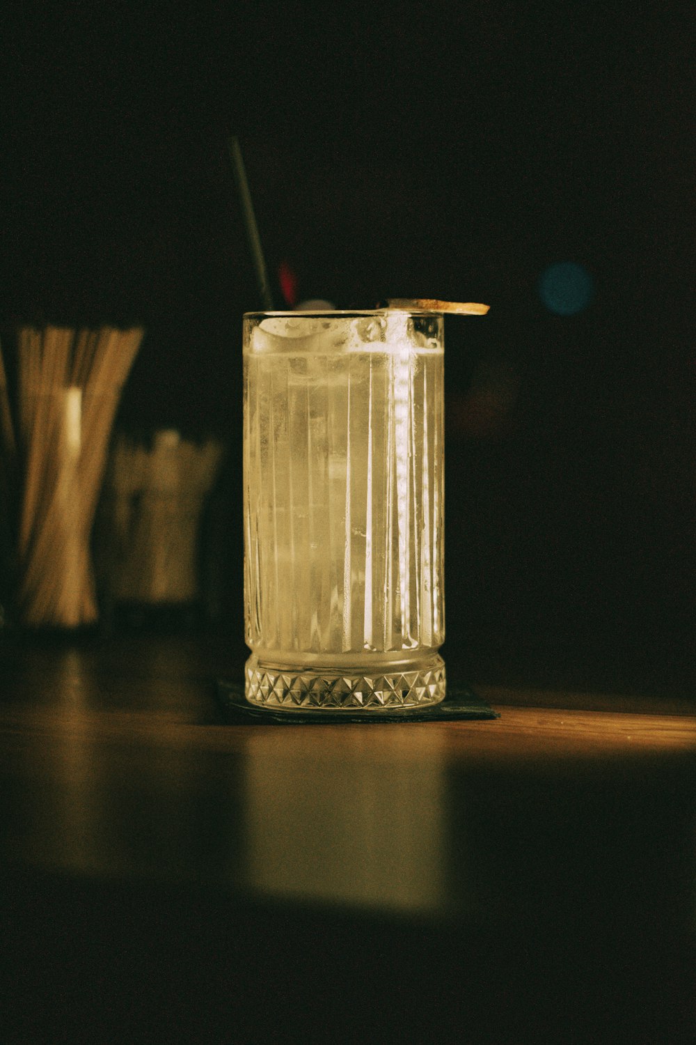 a glass with a straw in it sitting on a table