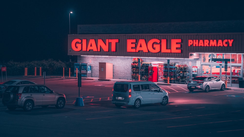 a giant eagle pharmacy store with cars parked in front of it
