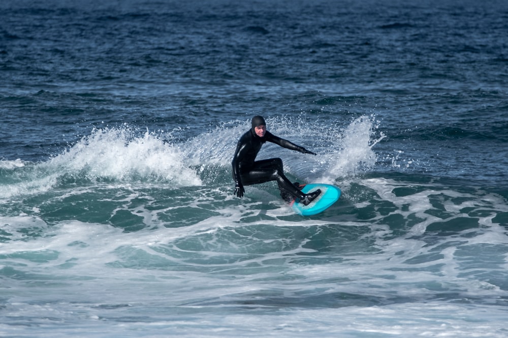 a man riding a wave on top of a surfboard