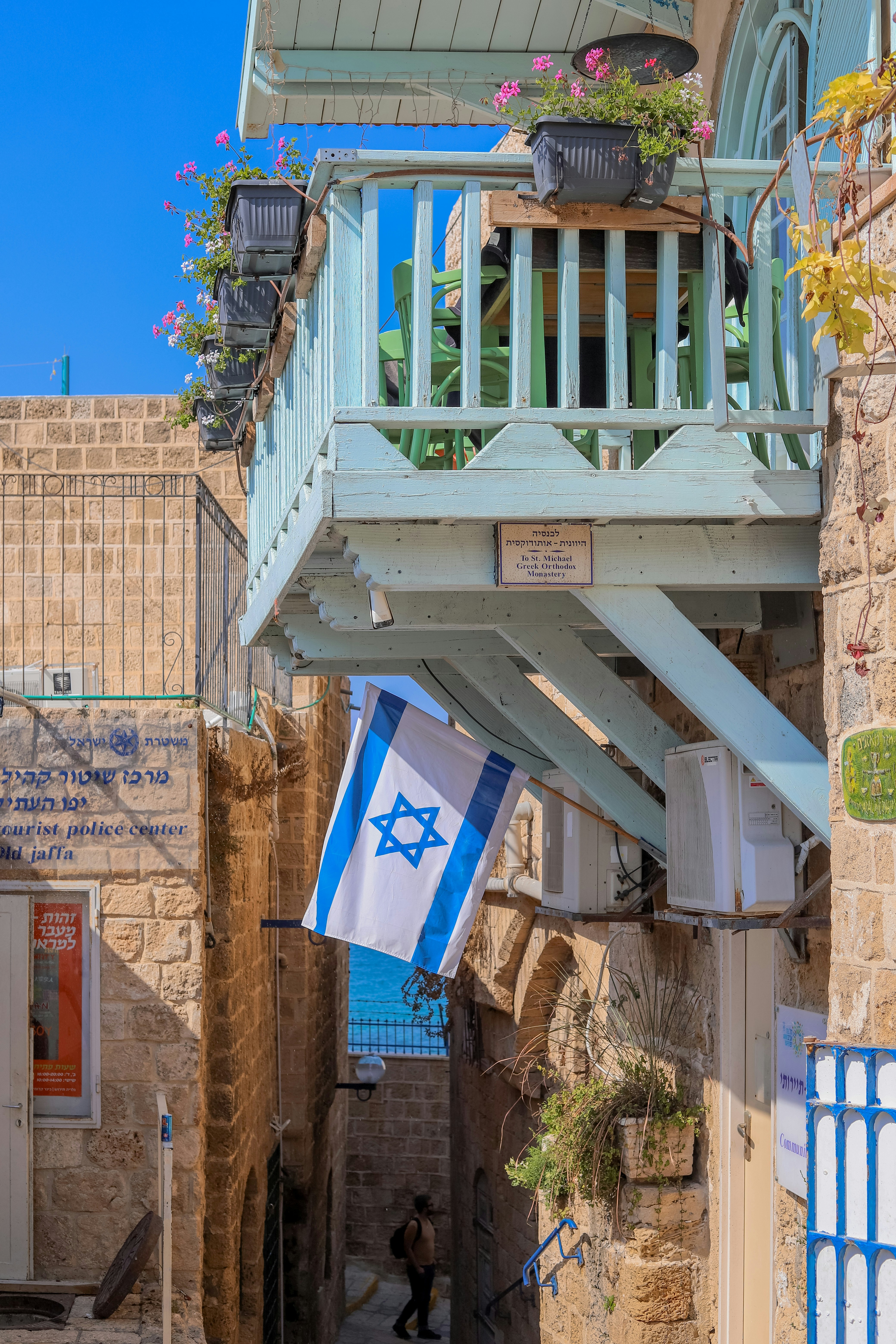 a blue and white flag hanging from a balcony