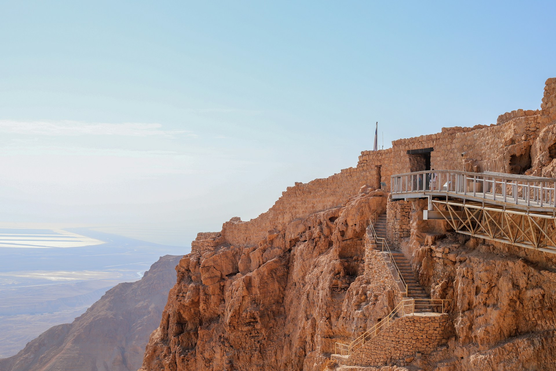 a wooden walkway going up the side of a mountain