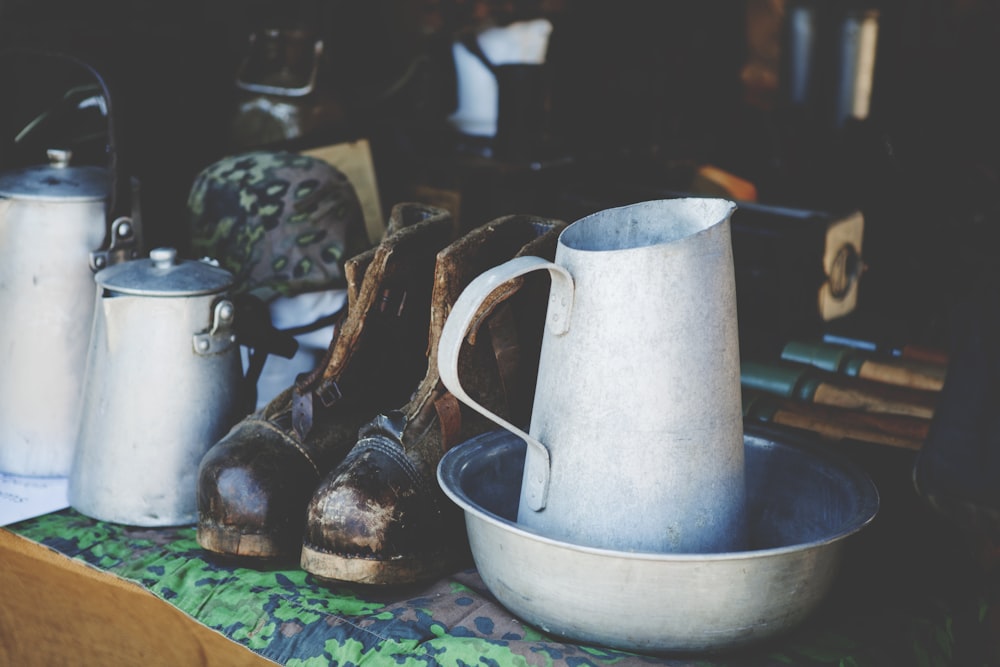 a table topped with a white pitcher and a bowl