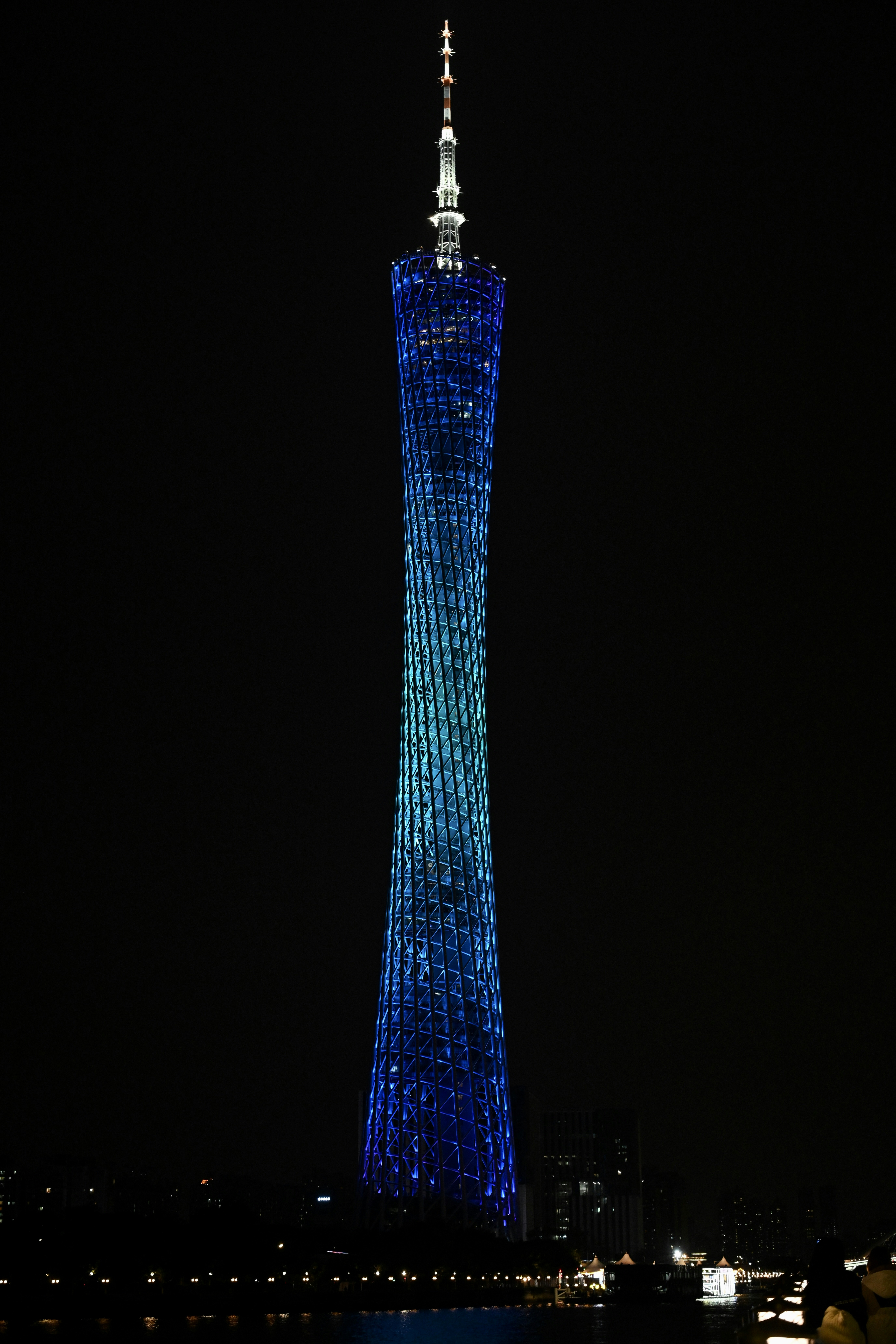 A very tall tower with a very bright blue top