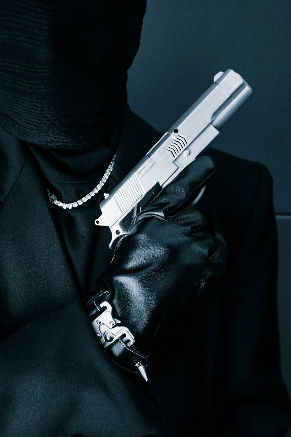a person in a black outfit holding a gun