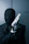 a man in a black suit holding a gun