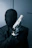 a man in a black suit holding a gun