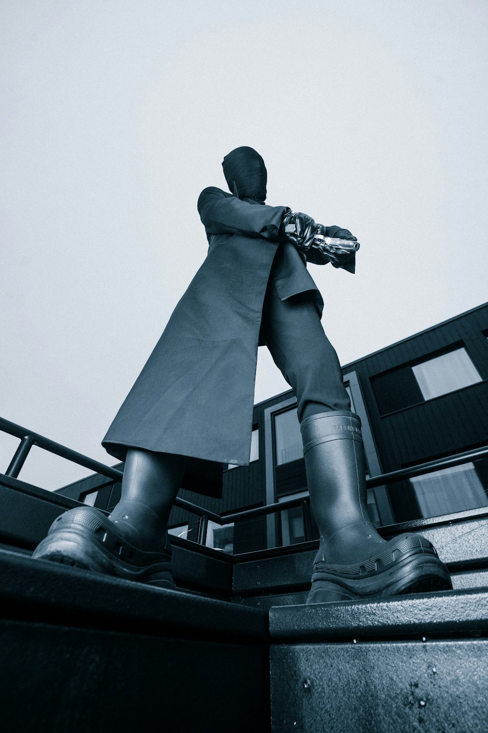 a statue of a man in a trench coat and boots