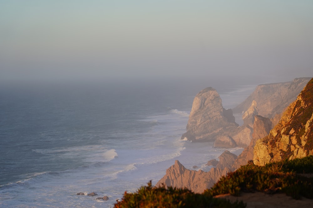 a view of the ocean from the top of a hill