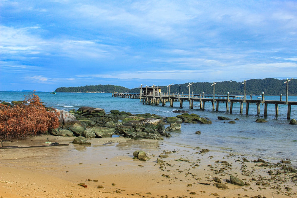 a pier on a beach near the ocean
