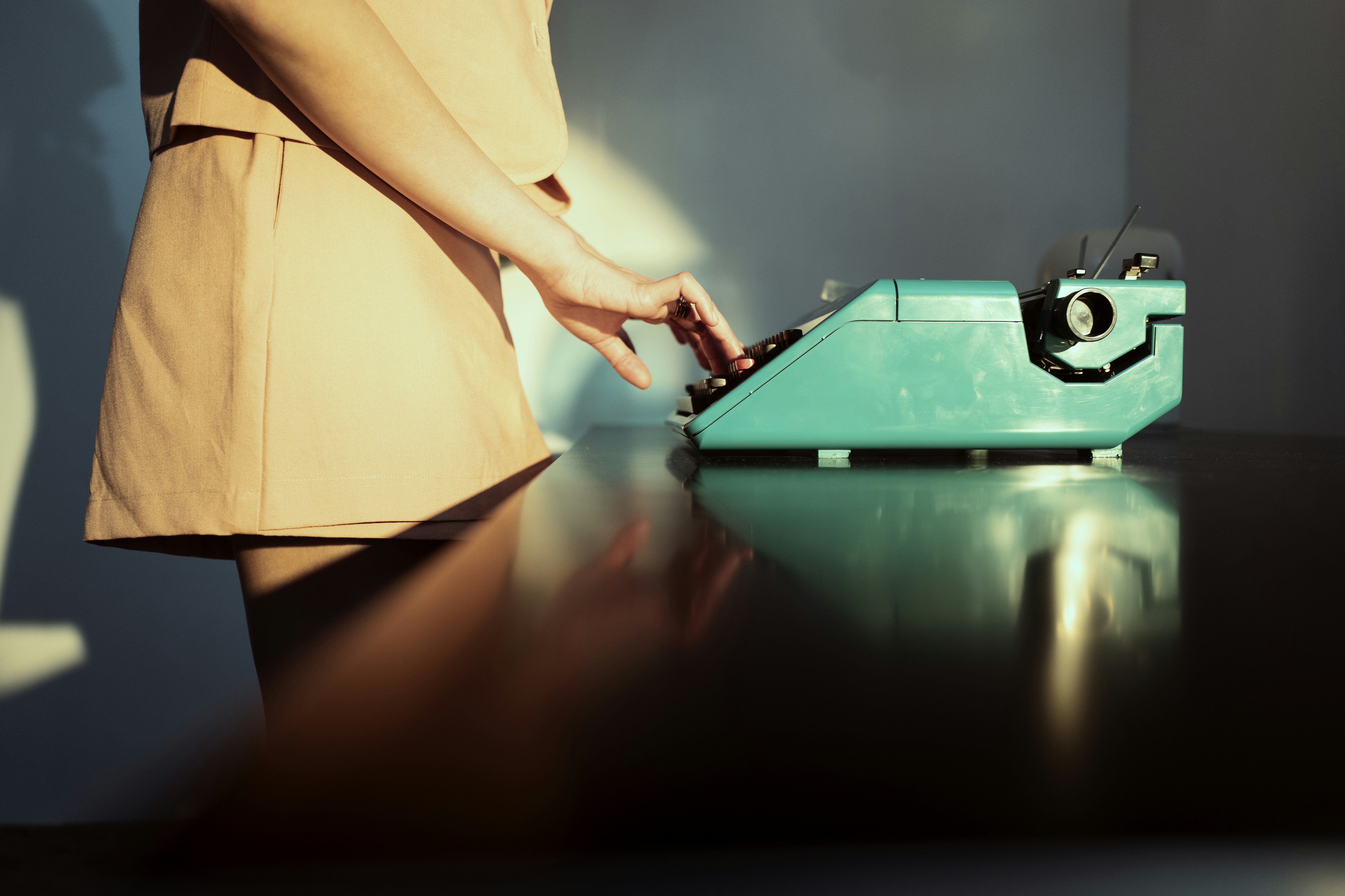 a person using a typewriter on a table, 