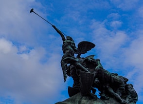 a statue of a man on a horse holding a flag