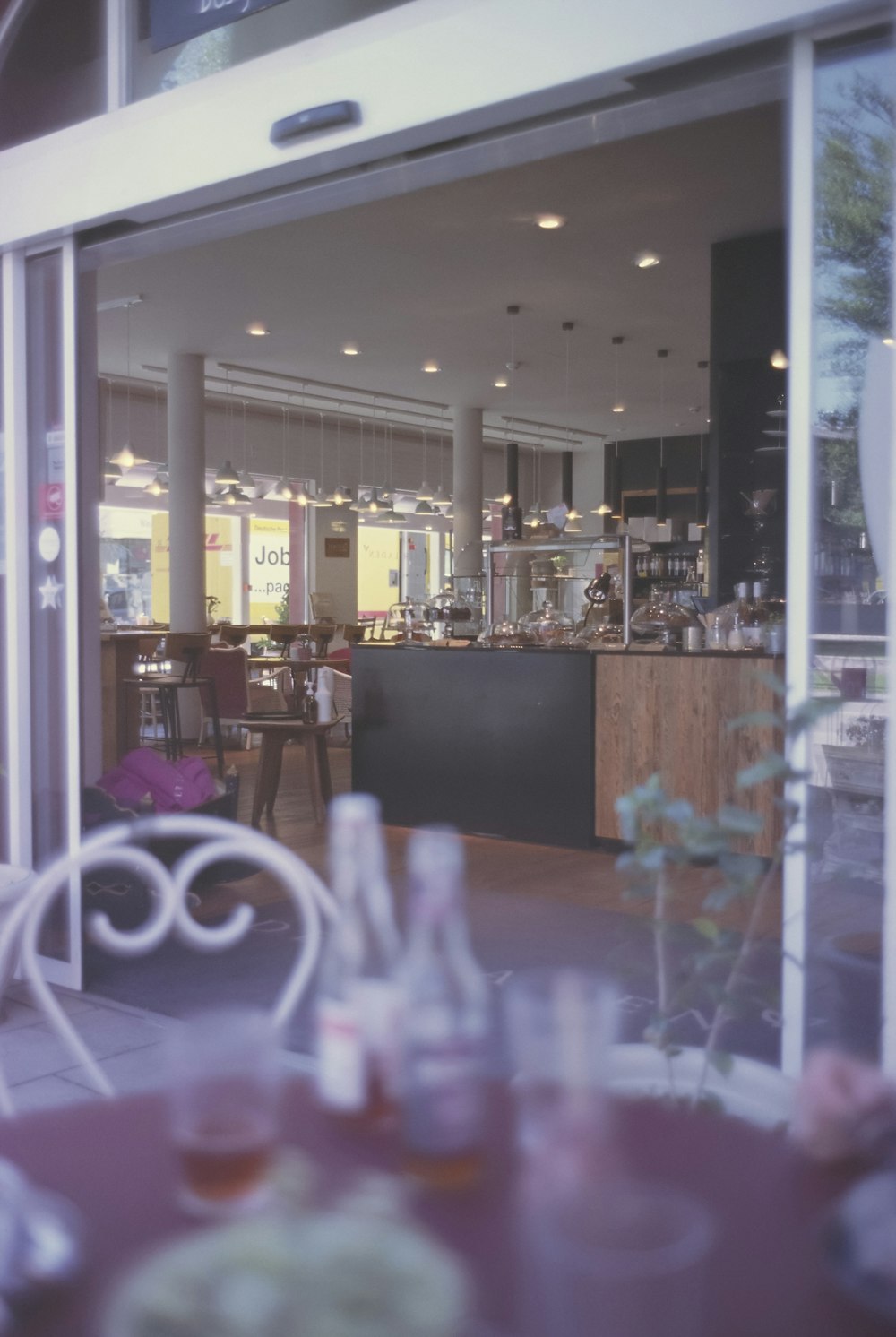 a view of a restaurant through a glass door