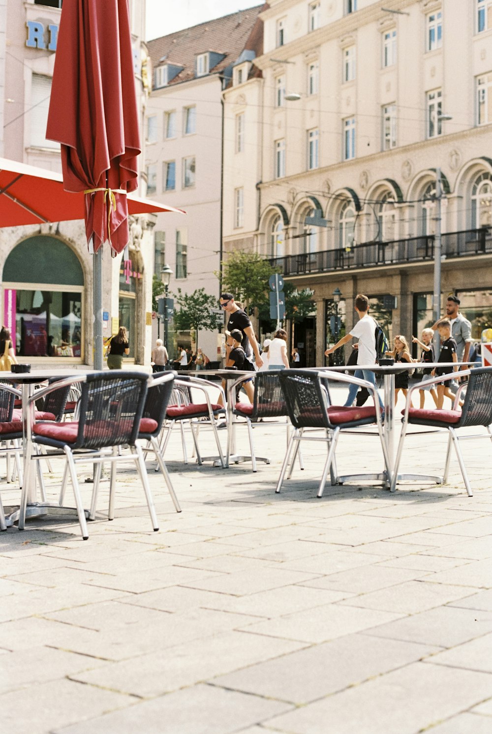 a group of chairs and umbrellas sitting on a sidewalk