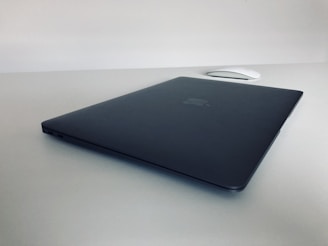 A close-up of a sleek laptop on a minimalist desk.