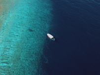 a small boat floating on top of a body of water
