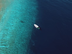 a small boat floating on top of a body of water
