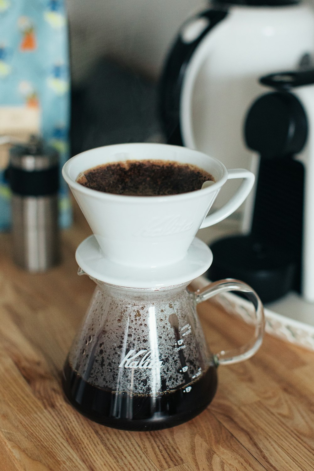 a coffee pot is sitting on a wooden table