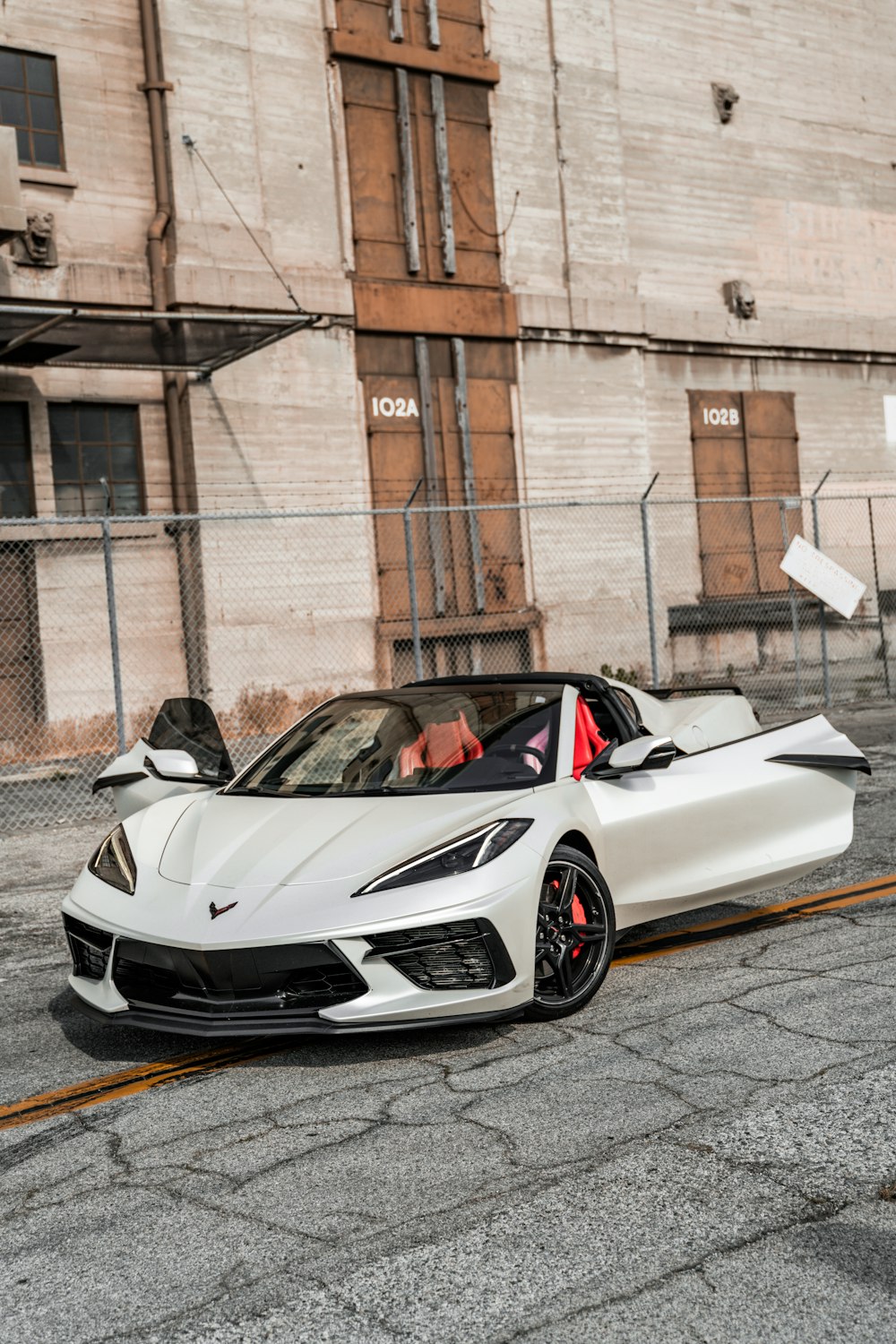 a white sports car parked on the side of the road