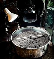 Roasting machinery in action capturing warm amber tones.